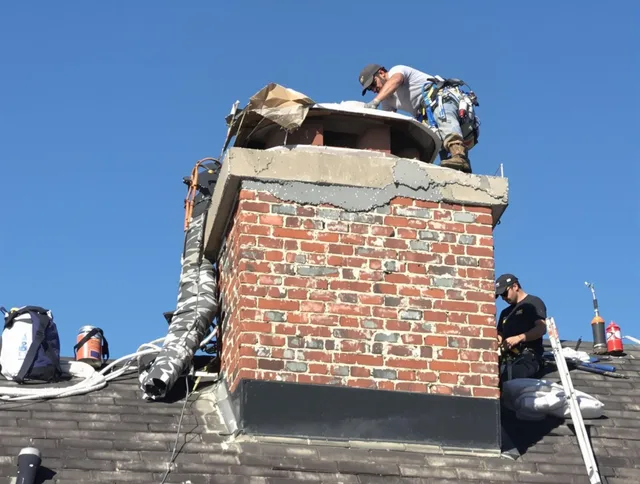 Hopkinton Chimney Sweep installing a custom chimney crown in Hopkinton, MA