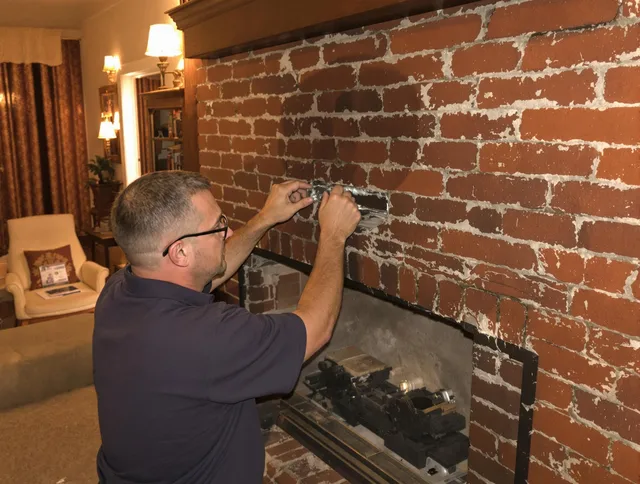 Hopkinton Chimney Sweep expert fixing a fireplace in Hopkinton, MA
